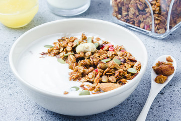 Paleo gluten free honey almond granola with  yogurt on dark concrete background. Selective focus, copy space.