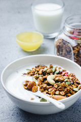 Healthy vegan granola yogurt breakfast on dark concrete background. Selective focus, copy space.