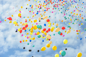 Multicolored balloons flying to the sky. © JKLoma