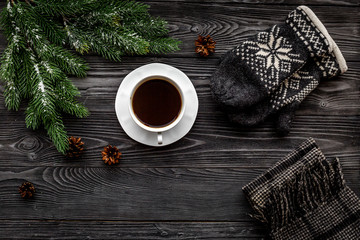 Cozy christmas evening. Knitten mittens and scarf on grey wooden background top view copyspace
