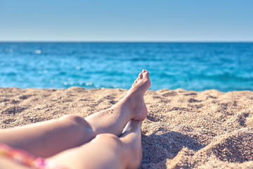 Fototapeta na wymiar Woman relaxing on the beach.