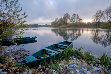 Boats near the bank of the autumn river
