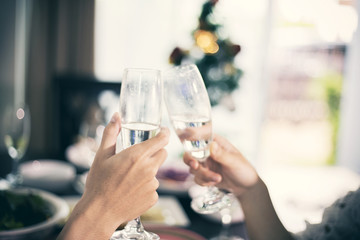 Asian young couple enjoying a romantic dinner  evening drinks while sitting at the dinning table on the kitchen together,soft focus