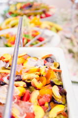 Many sliced fruits served on table