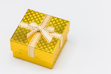 Single Gold gift box with silver ribbon on white background. Merry christmas, happy new year festival,valentine day concept.