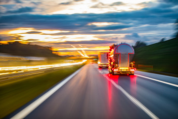 City evening lights, highway zoomed perspective blurred by high speed of the car.