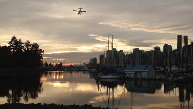 Float plane landing in Vancouver Stanley Park waterfront in the morning