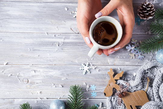 Woman holding in hands hot christmas tea with candy