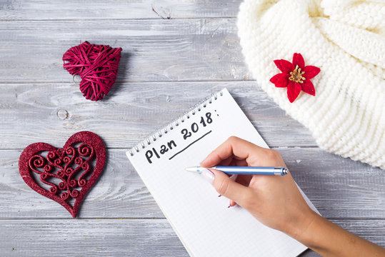 Top view of hand writing on a blank notebook