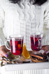 woman holding a tray with mulled wine