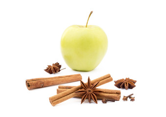 Aromatic apple, star anise, cloves and cinnamon isolated on white background