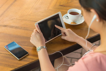 Asian girl listening to Podcasts outdoors
