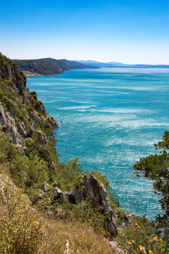 Italian coast, blue sea water in a sunshine, close to Sistiana and Duino - Aurisina. The Gulf of Trieste