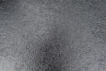 wet slippery shiny dark asphalt immediately after the rain
