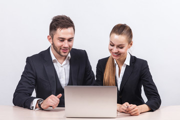 Picture of couple of office workers working together on PC