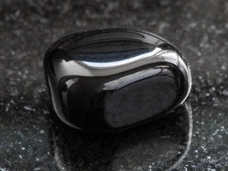 polished black Onyx gemstone on dark