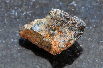 rough Psilomelane (manganese ore) stone on dark