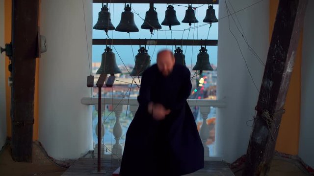 Priest in bell tower