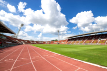 blurred red running track on athletic stadium