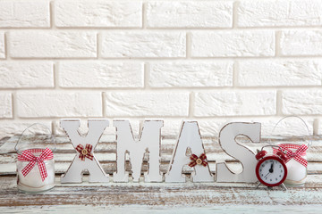 Christmas decorations. Christmas background. Watch, candle and Xmas text on wooden table.