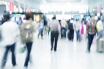 Obraz premium Traveler silhouettes in motion blur, airport interior