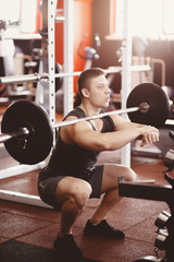 Fototapeta na wymiar man barbell. Athlete makes a squat with a barbell