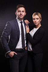 Picture of young couple of office workers standing