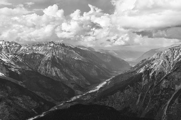 An aerial top black and white view of a river in mountain canyon. Concept of calendar about Caucasus Mountains and Karachai-Cherkess in Russia. Black-and-white greyscale photo with high contrast.