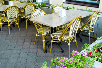 Wicker chairs and tables in a cafe on the street