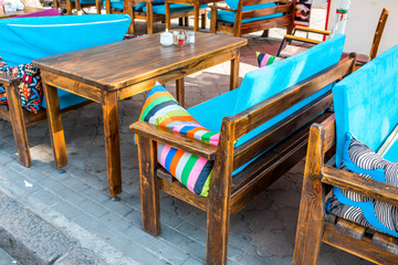 Fototapeta premium outdoor wooden furniture in a cafe on the street