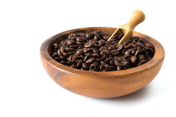 Coffee beans close-up in a wooden bowl of isolate on a white background