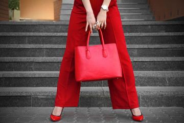 Young woman in bright clothes with stylish bag, outdoors