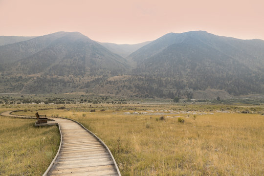 A wooden walkway at Mono Lake in California at sunset