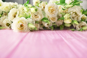 Beautiful eustoma flowers on wooden table