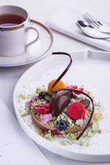 Sorbet from bitter chocolate with raspberry and sea-buckthorn, is served with berries