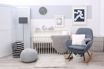 Baby bedroom design with white crib and rocking chair