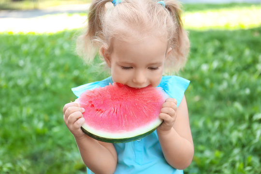 Cute girl eating watermelon, outdoors
