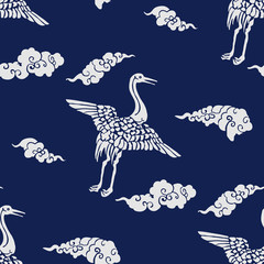 Indigo dye seamless  stencil pattern, Japanese traditional motif with cranes and clouds. Ecru on navy blue background. Textile design.