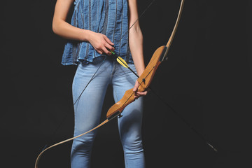 Young woman with bow on dark background