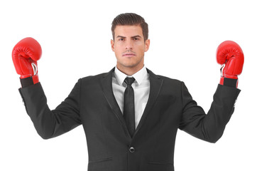 Businessman in boxing gloves on white background