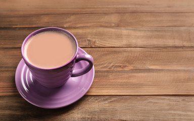 Cup with yummy cocoa on wooden table