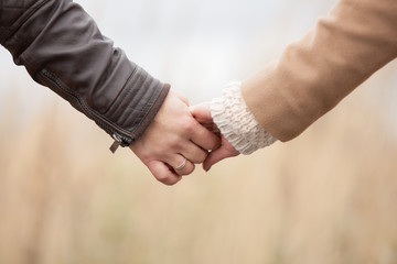 Closeup photo of couple, holding hand in hand.