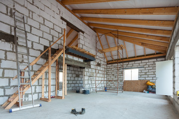 Ladder, parts of scaffolding and construction material on the floor during on the remodeling,...
