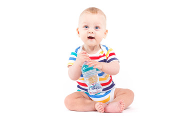 cute baby boy in colorful shirt with water