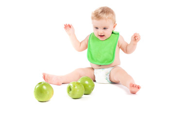 cute happy little boy in green bib play with apples