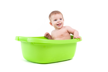 little pretty baby boy take bath in green tub