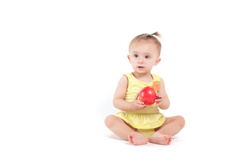 pretty cute little girl in yellow dress with apple in hand