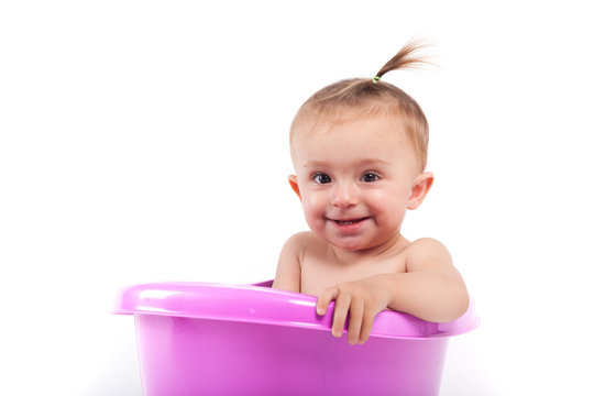 happy cute baby girl take bath in green tub