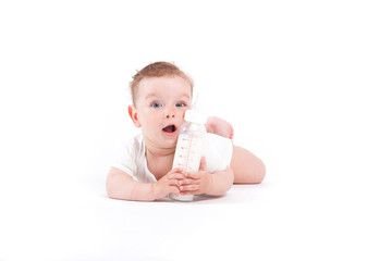 cute happy little boy in white shirt  hold milk bottle