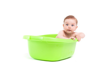 cute little baby boy take bath in green tub